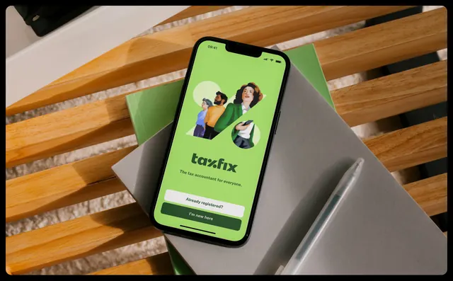 Taxfix app welcome screen on a phone in daylight, photographic, illustrated, vibrant