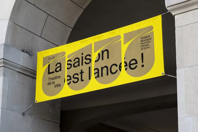 Theatre de la Ville yellow fabric banner under an arch, swiss, geometric, vibrant