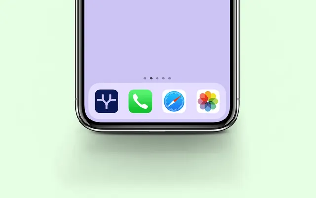 Tradeer app icon in a cropped phone dock, minimal, photographic, light