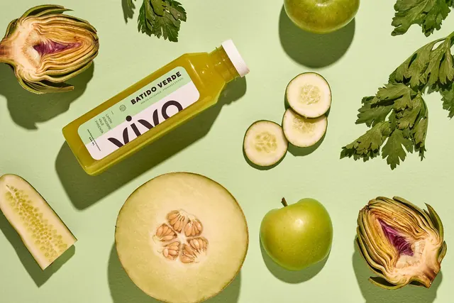 Vivo Batido Verde bottle in a green produce flat lay, photographic, minimal, muted
