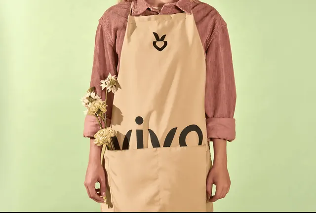 Vivo branded apron with sprout mark, photographic, minimal, warm