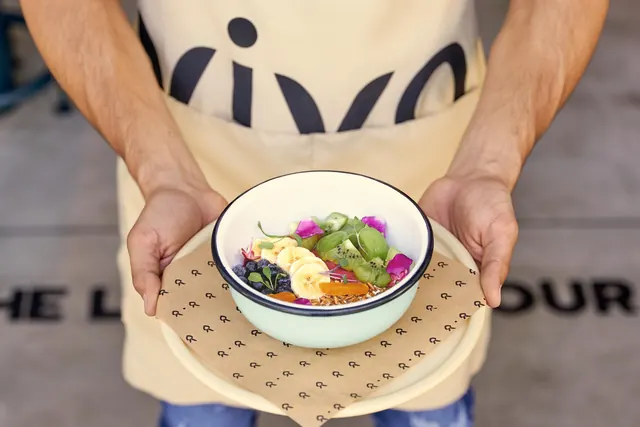 Vivo fruit bowl served on branded wrap paper, photographic, organic, warm