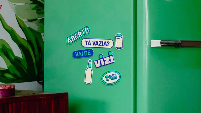 Vizi stickers applied to a green fridge door, photographic, playful, vibrant