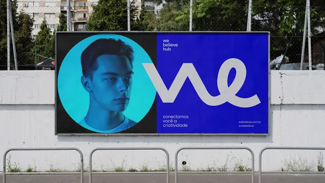 We Believe Hub blue billboard with circle portrait, geometric, flat, vibrant