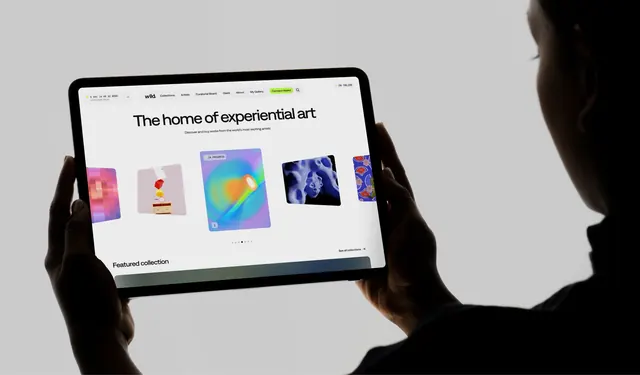 In-hand tablet mockup of the art platform homepage, photographic, minimal, light