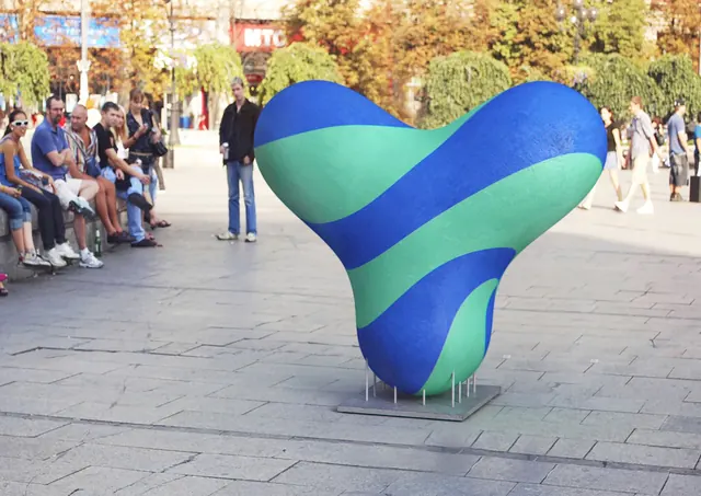 Yezzz! blob sculpture in a city square, organic, abstract, vibrant
