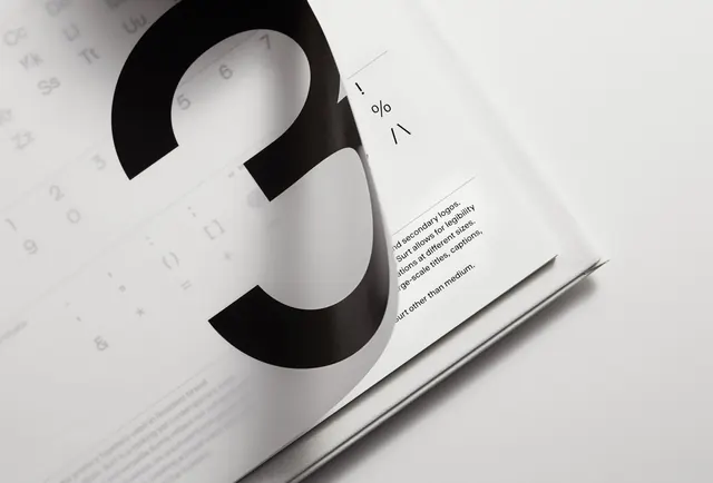 Large serif ampersand on magazine page with text, editorial, swiss, light