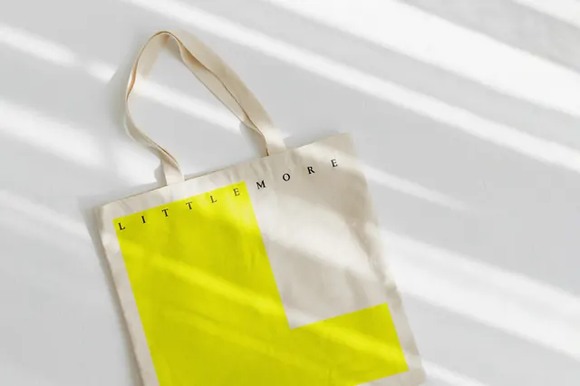 Little More tote bag flat lay, minimal, editorial, light