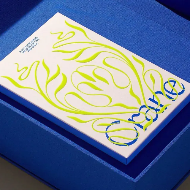 Crane gift box with neon swirls on blue fabric, minimal, vibrant, vibrant