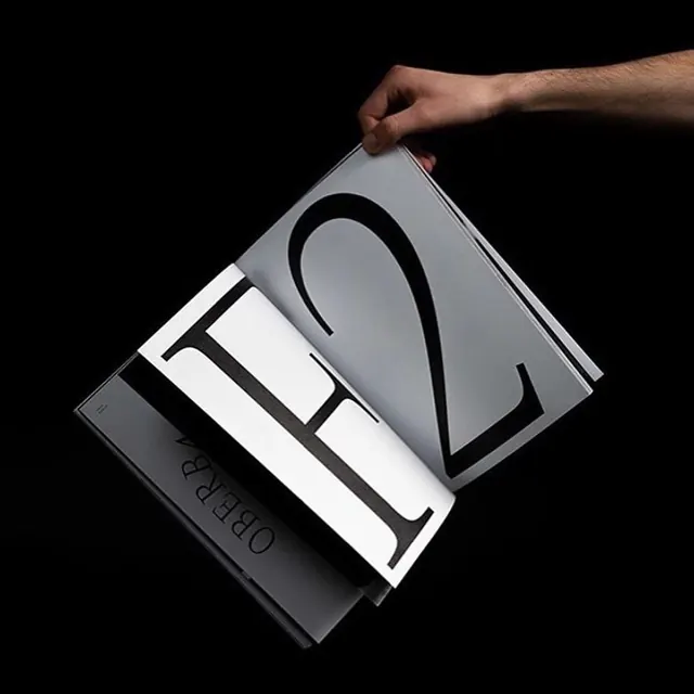 Handheld typographic book spread, editorial, minimal, monochrome