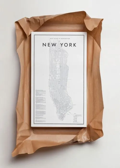 Manhattan map poster flat lay on kraft, minimal, editorial, monochrome