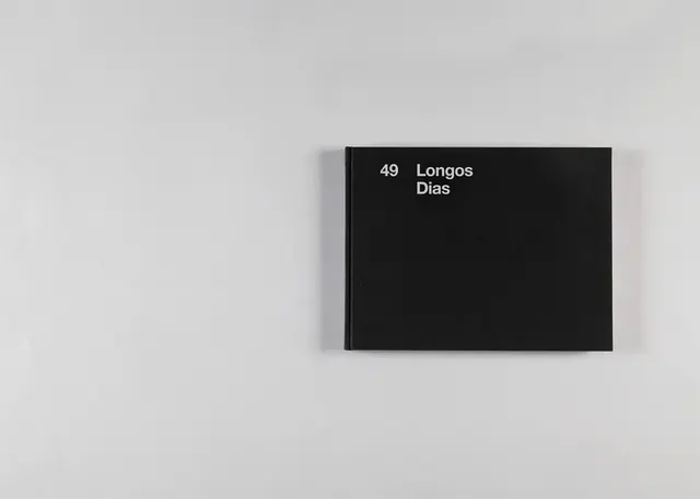 Minimal product shot of black book cover, minimalist, boxed, light