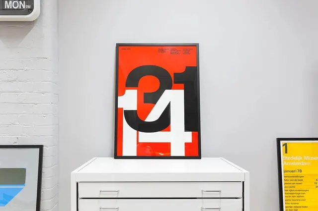 Red and black geometric poster in framed grid, geometric, bold, vibrant