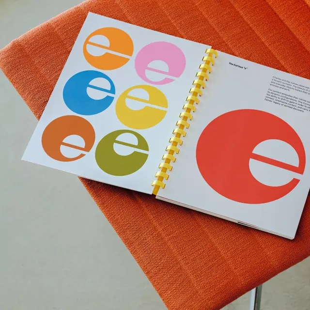 Design book with colorful circular letter illustrations, playful, editorial, vibrant