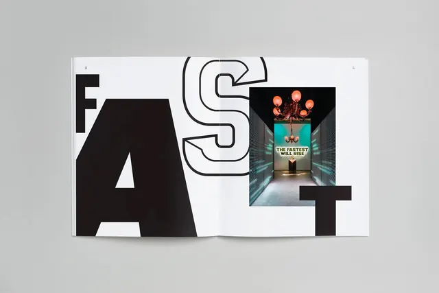 Magazine spread with bold geometric letters and colorful image inset, editorial, swiss, monochrome