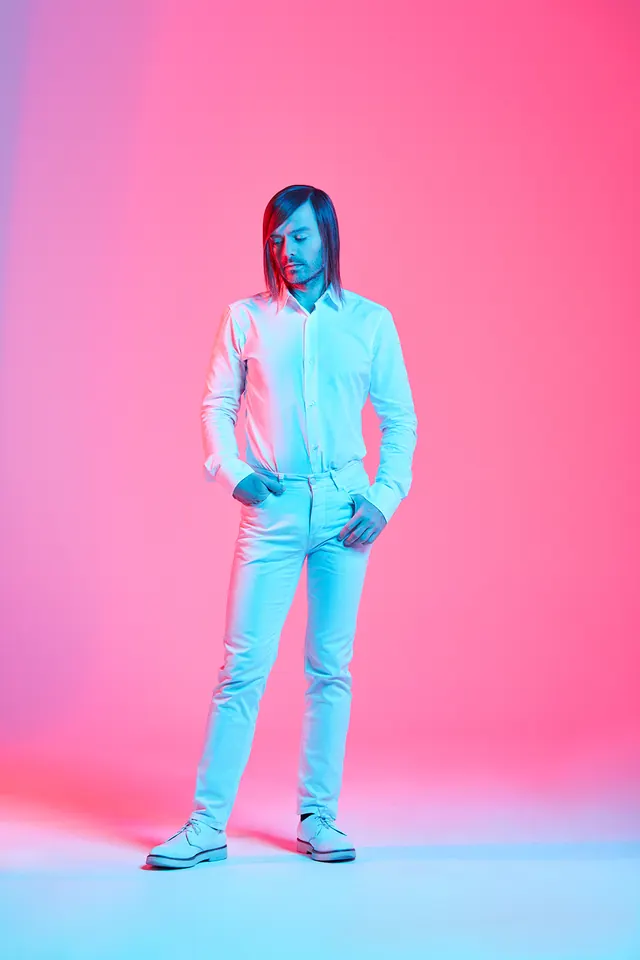 Duotone figure against pink-blue gradient, photographic, gradient-heavy, vibrant