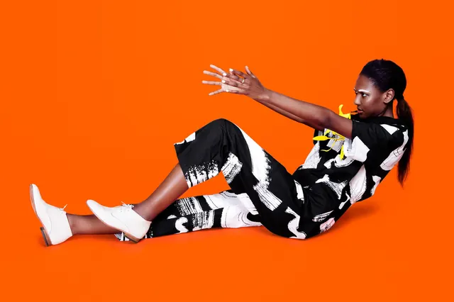 Orange-background fashion portrait, photographic, bold, vibrant