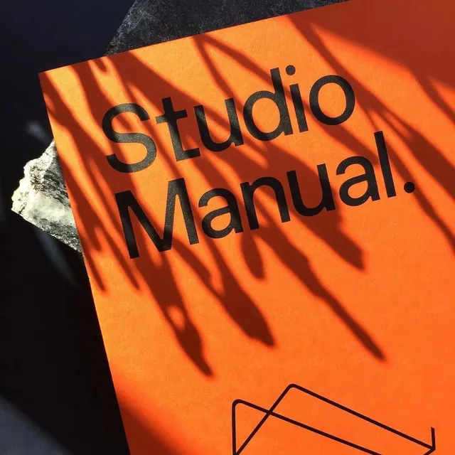 Typography-focused still life with orange paper, photographic, abstract, vibrant