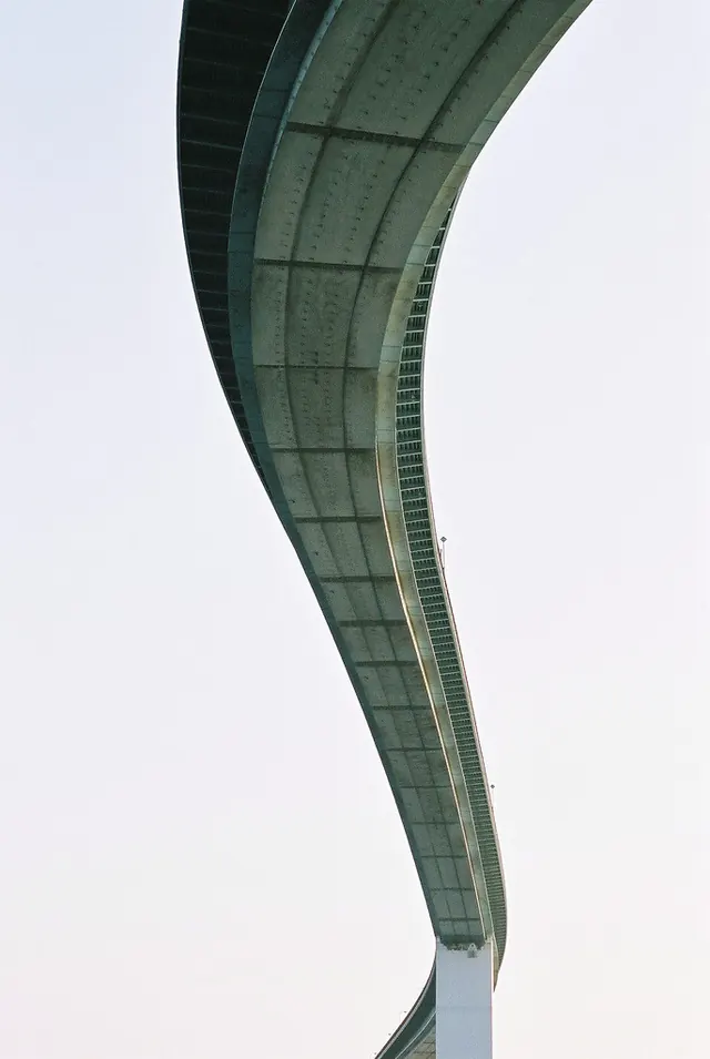Curved brutalist architecture detail, photographic, brutalist, dark