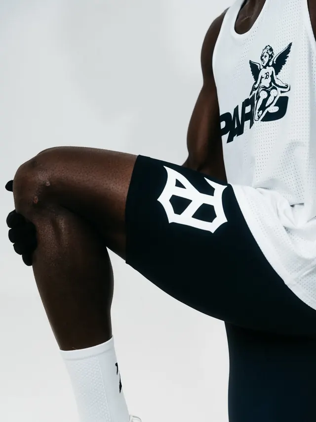 Monochrome athletic wear graphic with winged emblem, minimal, monochrome, dark