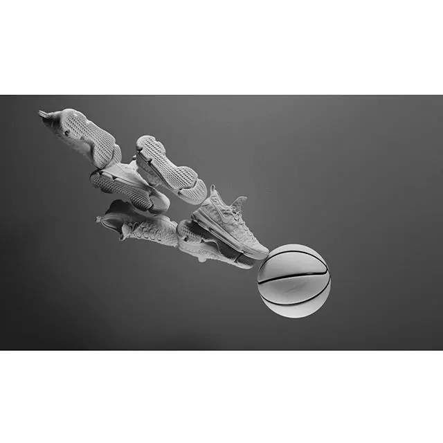 Athletic sneakers and basketball in monochromatic product arrangement, photographic, minimal, monochromatic