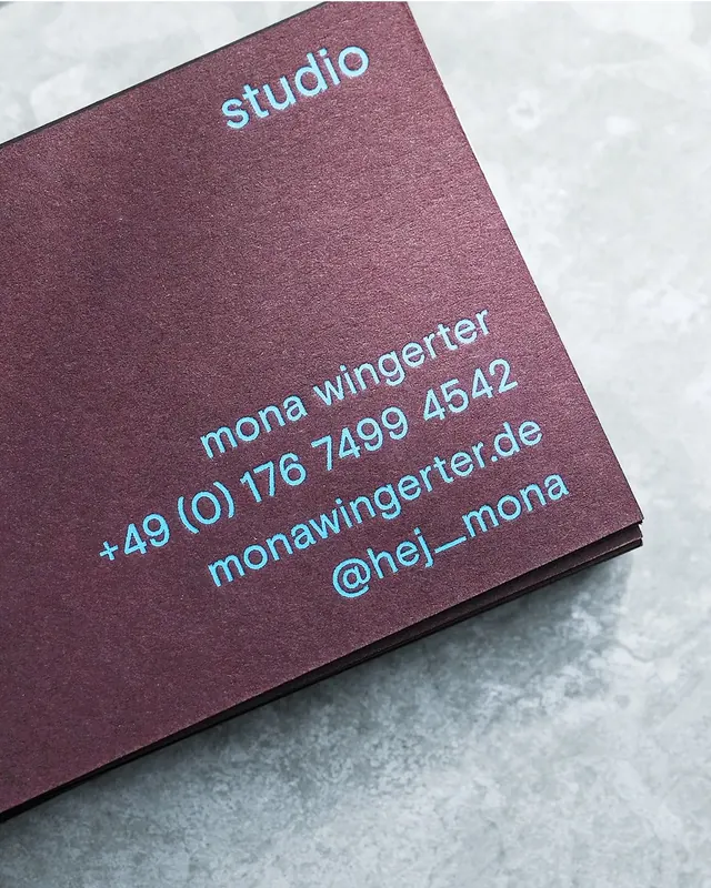 Studio contact card with cyan type on plum, minimal, corporate-clean, light
