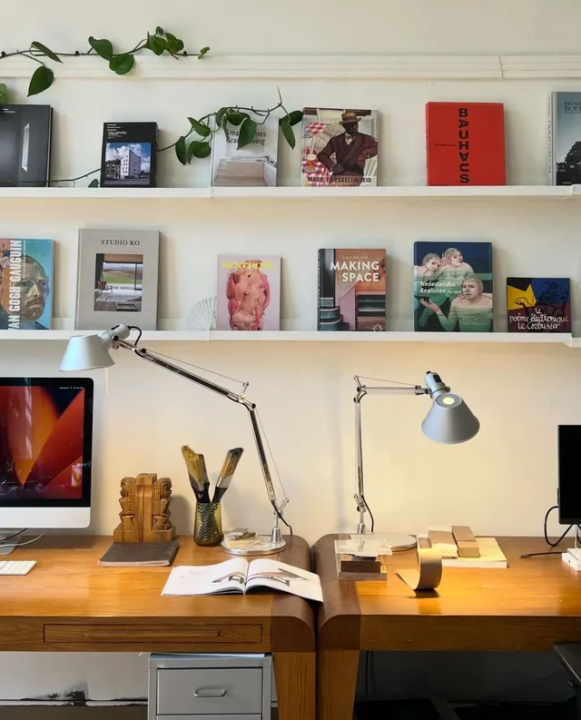 Designer workspace with floating shelves and wood desk, minimal, light