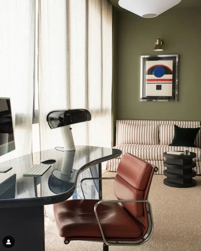 Mid-century modern office interior with olive-green walls, minimal, photographic, warm