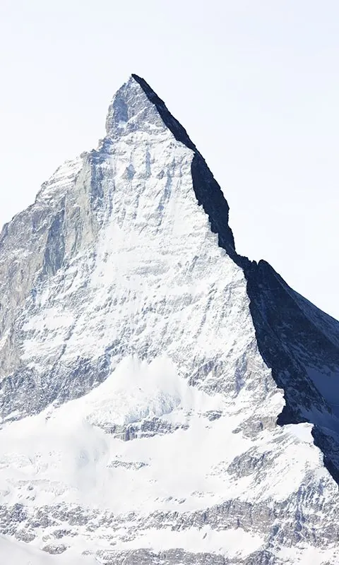 Snow-covered alpine peak with dramatic lighting, photographic, technical, light