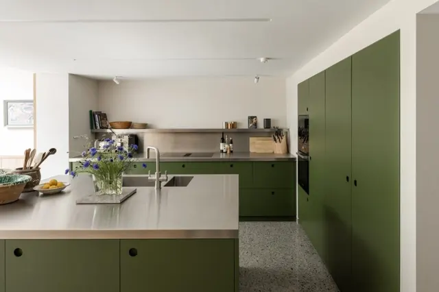Modern kitchen with sage-green cabinetry and open shelving, minimal, corporate-clean, light