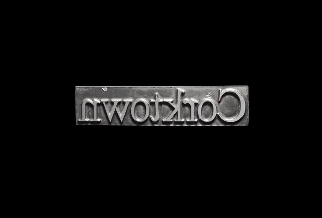 Metal letterpress block for Corktown, minimal, monochrome, dark