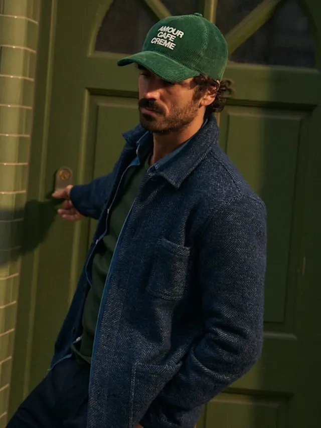Man in Blue Jacket with Green Beanie, photographic, dark