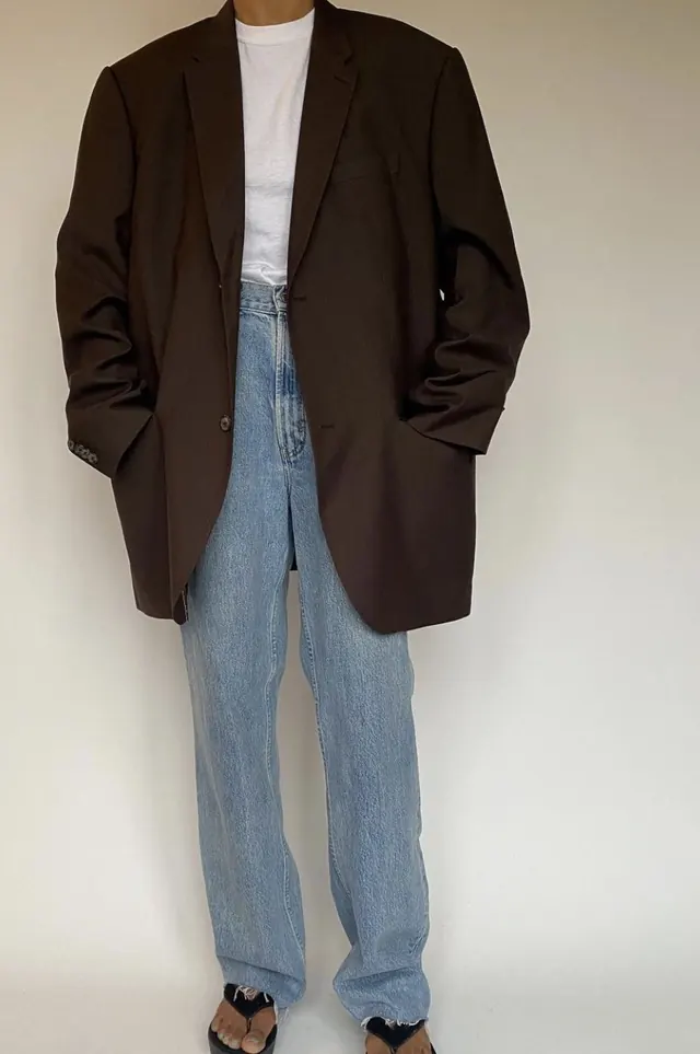 Oversized blazer with light-wash denim, photographic, minimal, warm