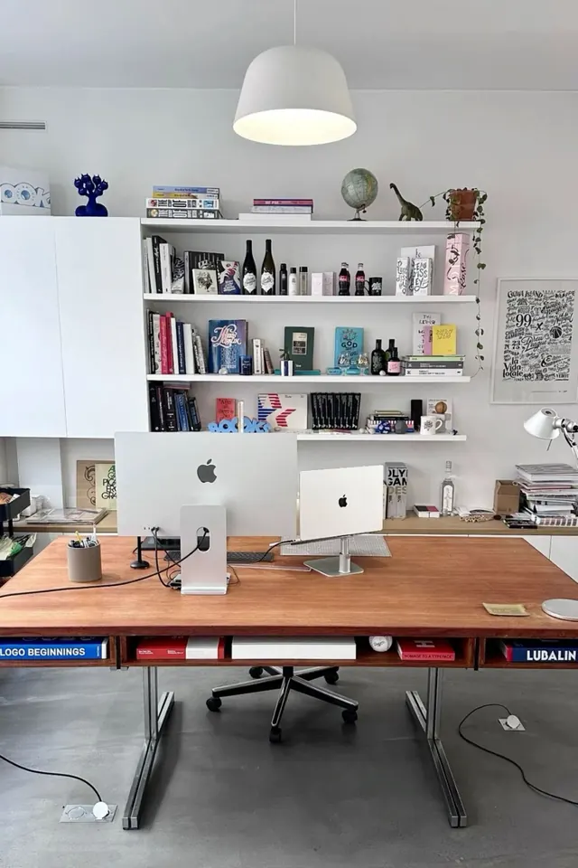 Minimal studio workspace with floating shelves and natural wood desk, minimal, light-mode, light