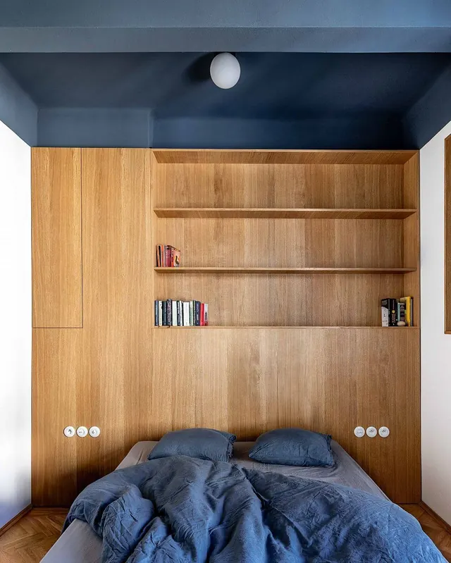 Bedroom nook with integrated shelving and accent ceiling, minimal, boxed, dark