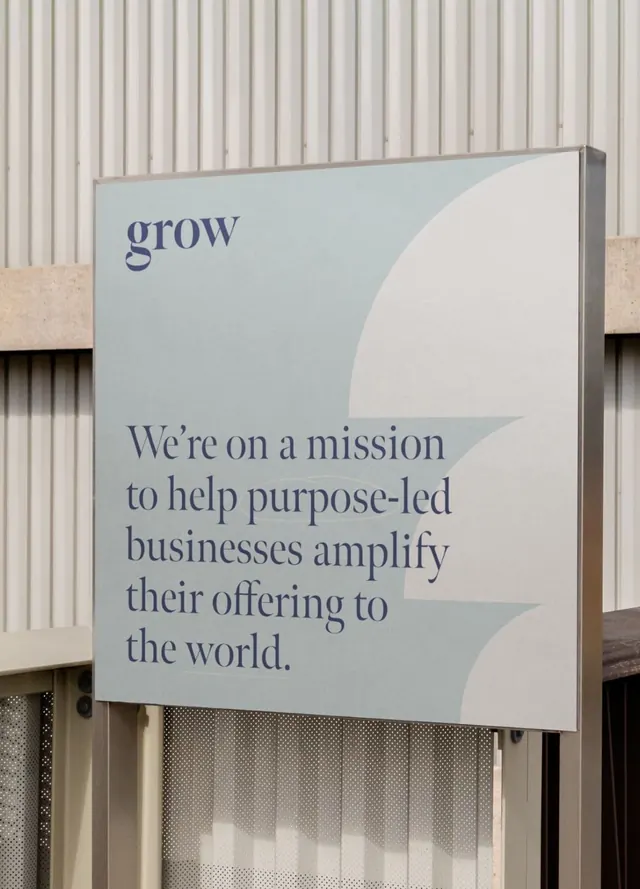 Mission statement signage with serif typography and organic curve, minimal, corporate-clean, light
