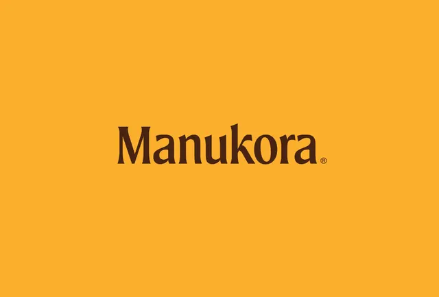 Manukora honey brand wordmark on golden background, minimal, organic, warm