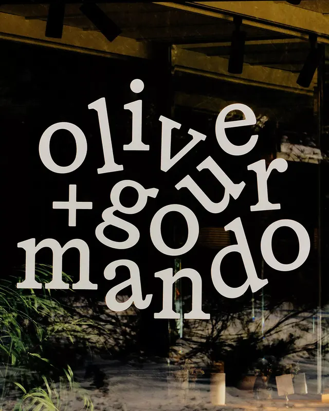 Storefront signage with serif-geometric letterforms, minimal, geometric, dark