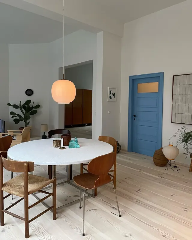 Mid-century modern dining interior with warm wood and blue accents, minimal, organic, warm