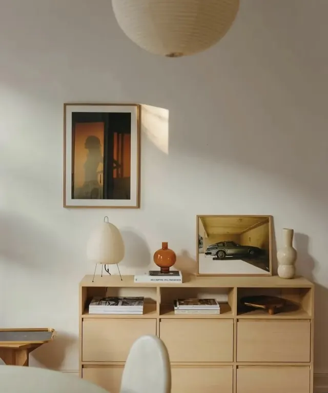 Mid-century modern shelving with curated vignette and framed art, photographic, organic, warm