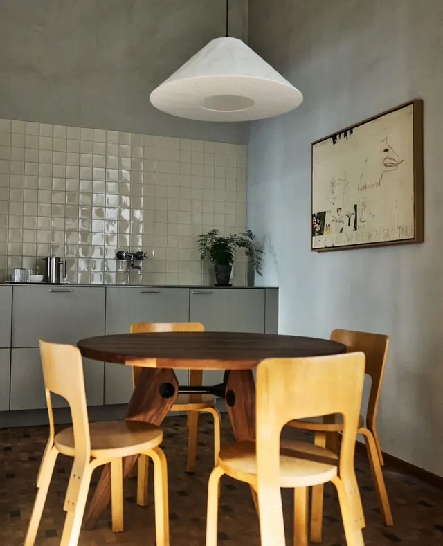 Midcentury dining room with UFO pendant and bentwood chairs, minimal, photographic, warm