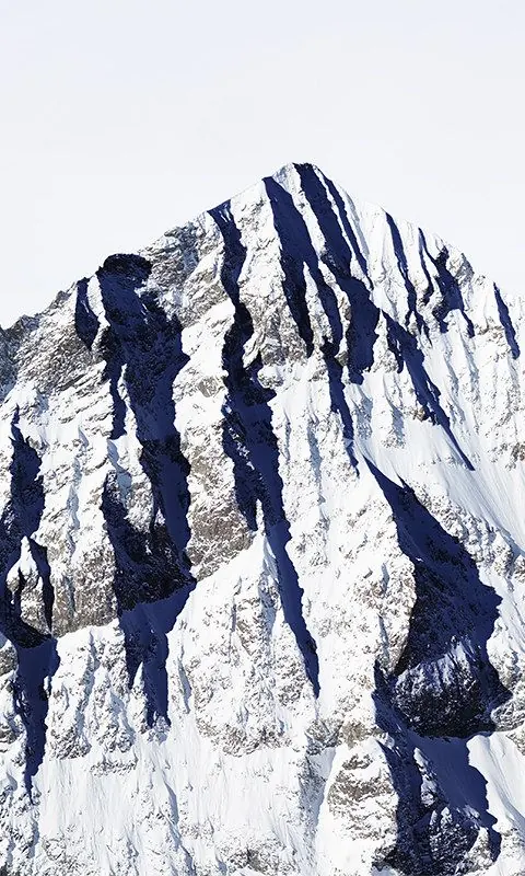 Alpine peak with deep shadow striations, photographic, light