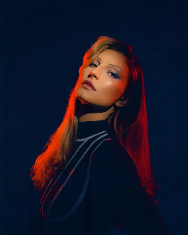 Portrait of a Woman in Dramatic Lighting, photographic, luxury, high-contrast