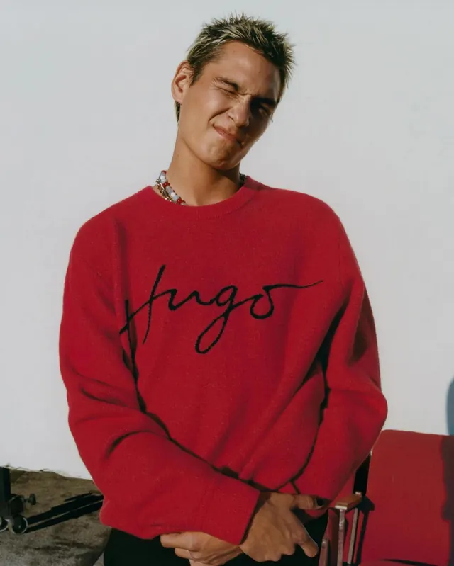Man in Red Sweater with Script Logo, photographic, minimal, vibrant