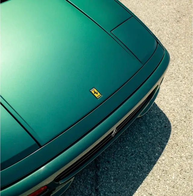 Green Car Detail with Badge, photographic, luxury, vibrant