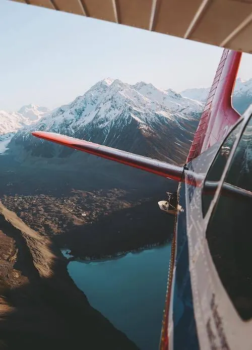 Aerial Mountain Landscape through Airplane Window, photographic, organic, cool
