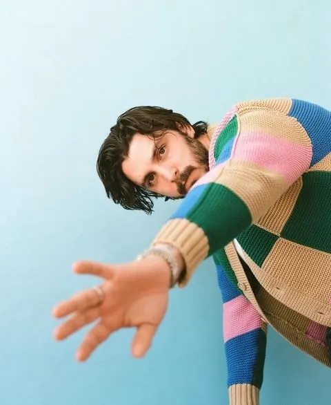 Man in Colorful Striped Sweater, photographic, playful, vibrant