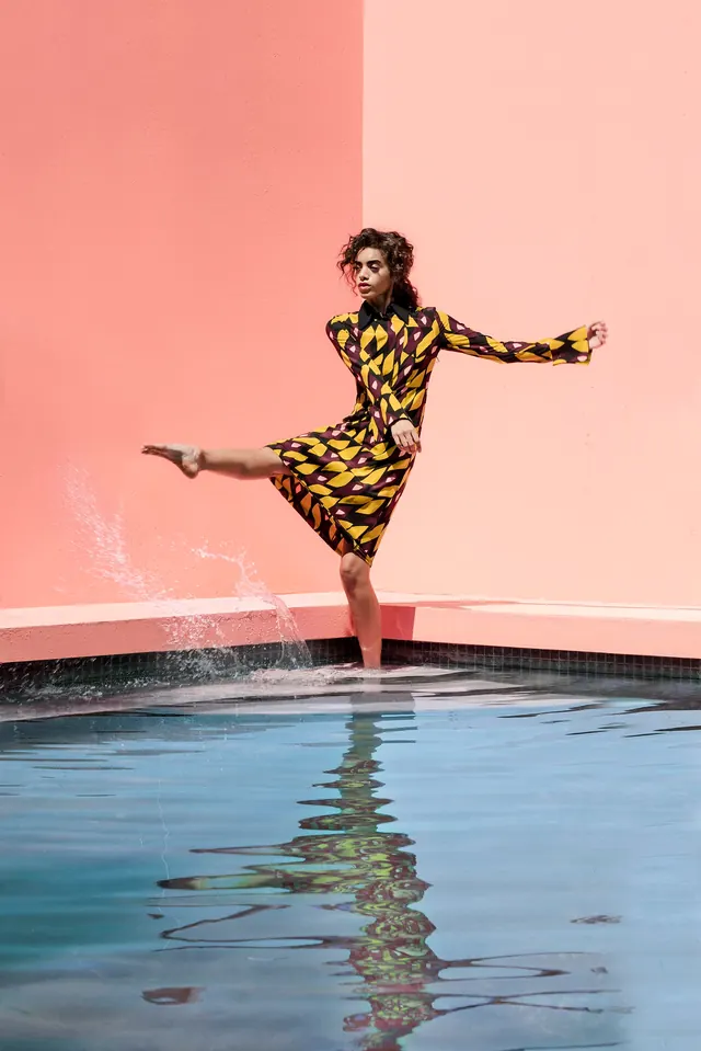 Woman in Yellow Dress in Pool, photographic, playful, vibrant