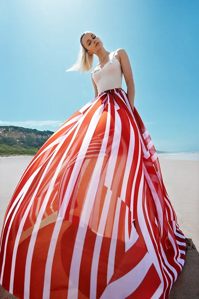 Woman in Striped Dress on Beach, photographic, luxury, vibrant