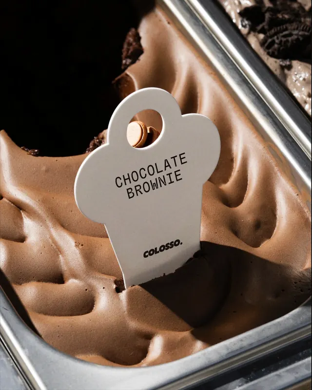 Minimal product tag on chocolate brownie, minimal, photographic, light